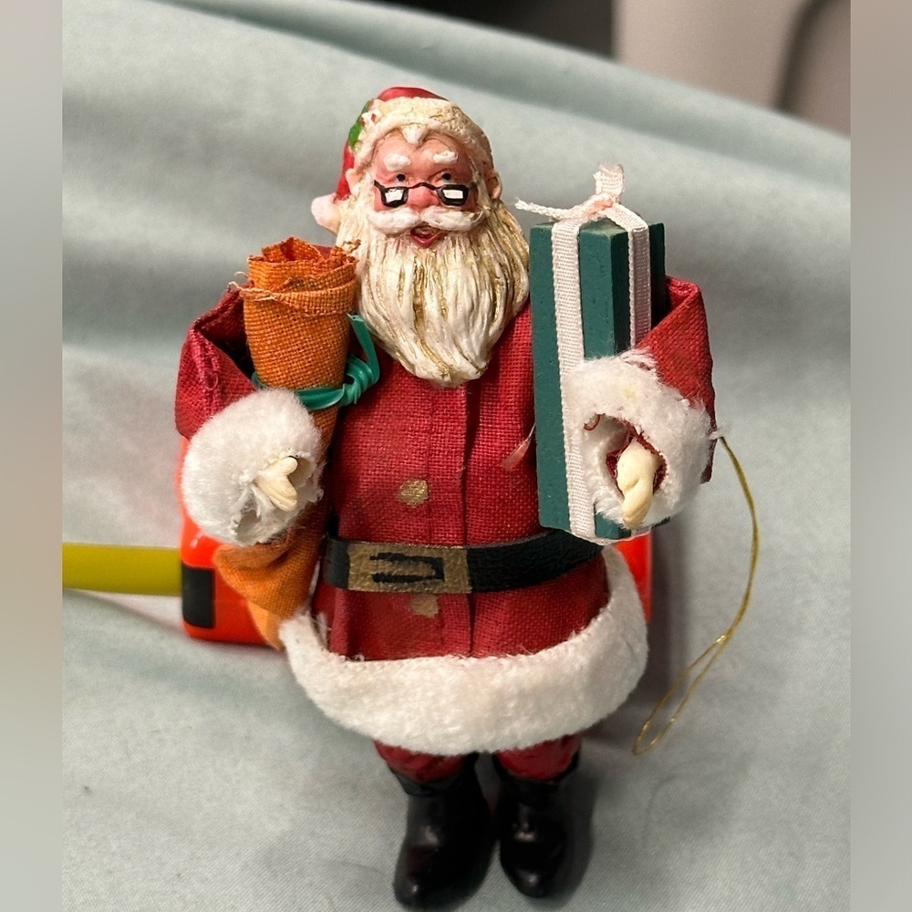 Vintage fabric ornament of Santa carrying gifts. Very good details!